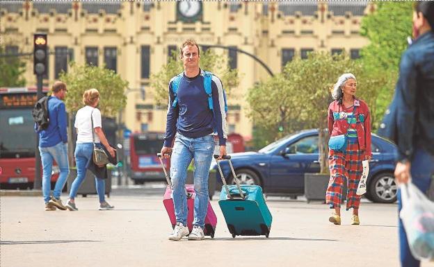 Un turista carga sus maletas a su llegada a Valencia en una imagen de archivo./Iván Arlandis