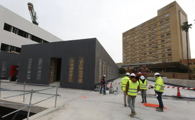 Obras del futuro centro de salud, al fondo uno de los edificios del antiguo hospital. 